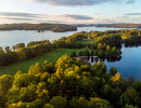 Drone image over the forest by a lake.