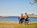 Two people are cycling on an island.