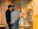 Museum visitors look at a historical exhibition.