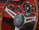 Closeup of a steering wheel of a car with the Saab logotype