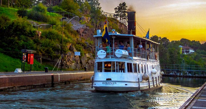 Båten Elfkungen åker i Trollhättans slussar under skymning