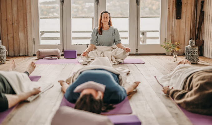 People doing yoga in a yoga studio.