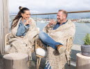 Man and woman on a balcony in an archipelago environment.