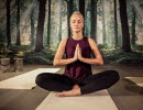 A dark yoga studio with people practicing yoga. 