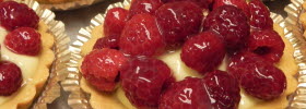 Close-up of cookies with raspberries on the top.