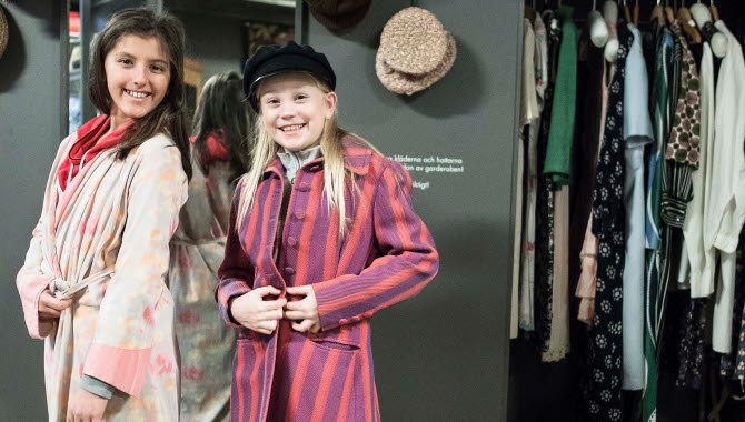 Children try out fashion clothing at Mölndals Stadsmuseum.