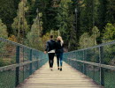 A couple walking over a bridge