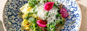 Colorful food on a bluish-white floral plate