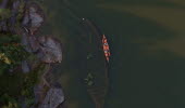 An overview of a ship wreck lying visible in a lake with a kayak on the side.