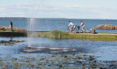 Two people bilking along the shore of Lake Vänern.