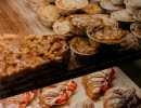 Pastries lying on shelves in a cafe
