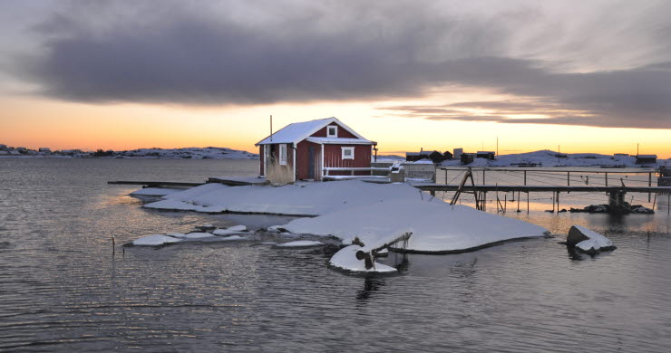 Boathouse in winter landscape