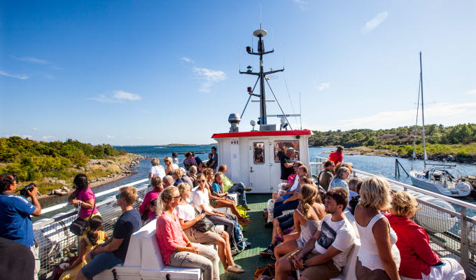 People sit on the upper deck on their way out to Koster Islands with the Koster boat.