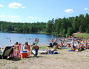 Lilla Havsjön located on the Hökensås nature reserve. People like the sun on the beach and people swimming in the lake.
