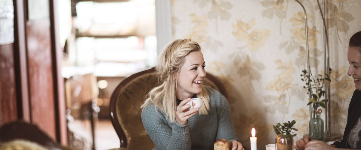 Woman enjoying cinnamon buns and coffee