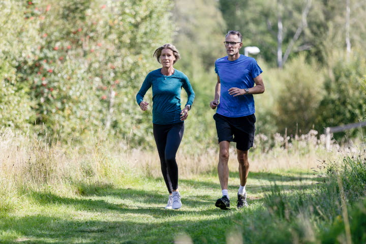 Woman and man running in an exercise track.