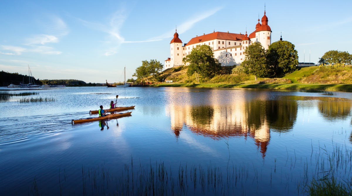 Couple kayaking outside a white castle