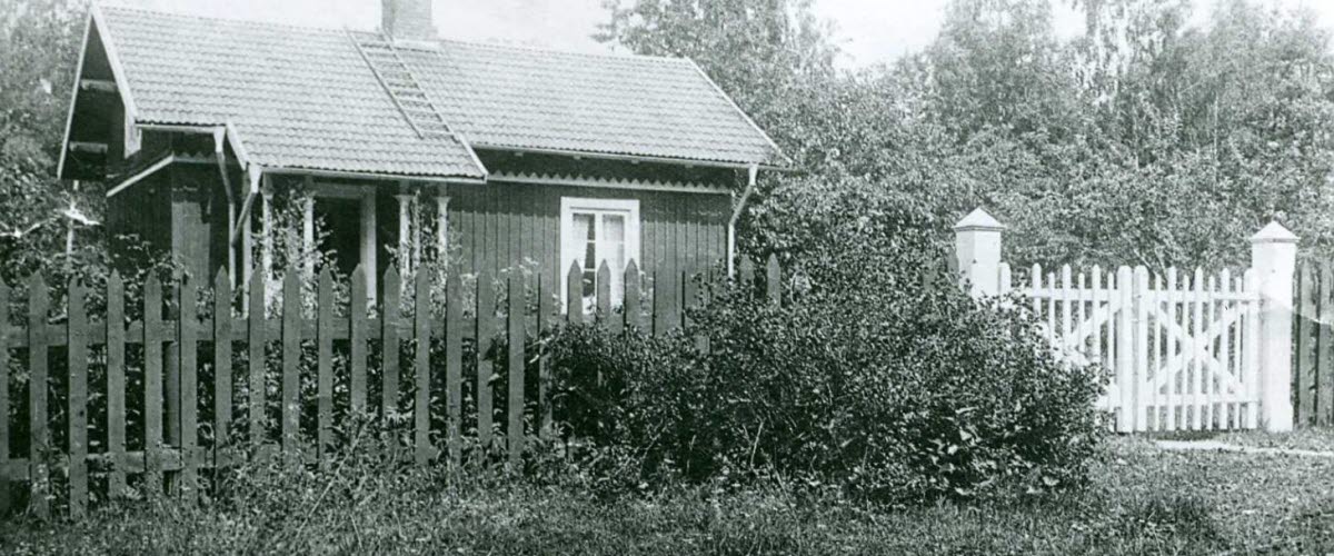 Black and white archive image of a small cottage.