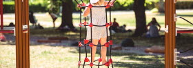 Girl climbs in climbing position.