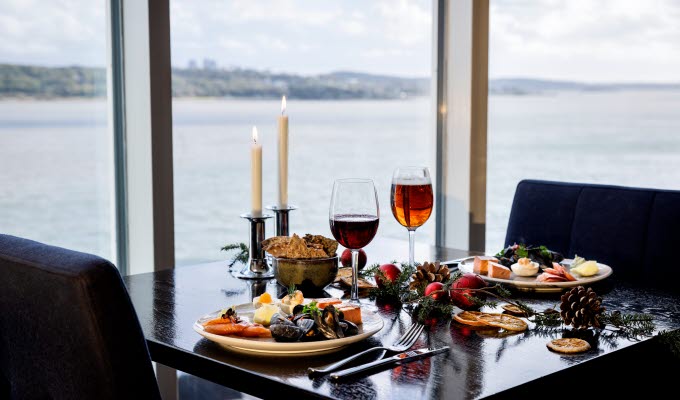Set table with Christmas food.