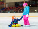 Children skating on indoor ice rink