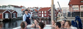 Group of people sharing a bath in a hot tub at Smögen in winter time