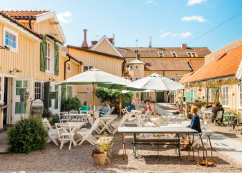 Group of people sitting on an outdoor terrace.