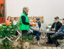 Group of people sitting on an outdoor terrace.