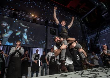 Two people carrying the winner of European Oyster Opening Championships