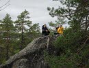 A woman and a man sitting on a small mountain.