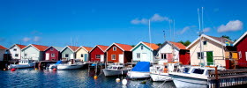 Boat houses with anchored small boats at the docks on North Koster.