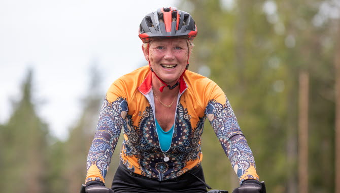 Female biker with helmet and colorful clothes.