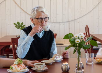 A group enjoying coffee outdoors, sitting at a table.