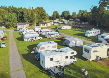 Campingplats med husbilar och husvagnar.