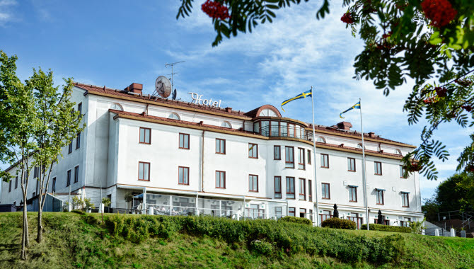 Ståtliga Hotell Bogesund med flaggor i topp en sommardag i Ulricehamn.