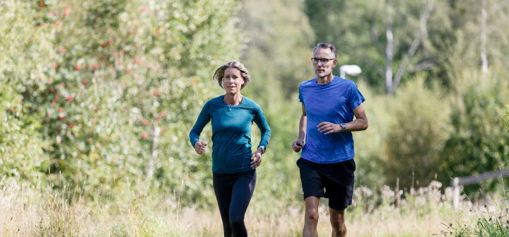 Woman and man running in an exercise track.