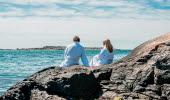 People sit by the sea.