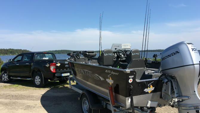 Car with a boat on a trailer.