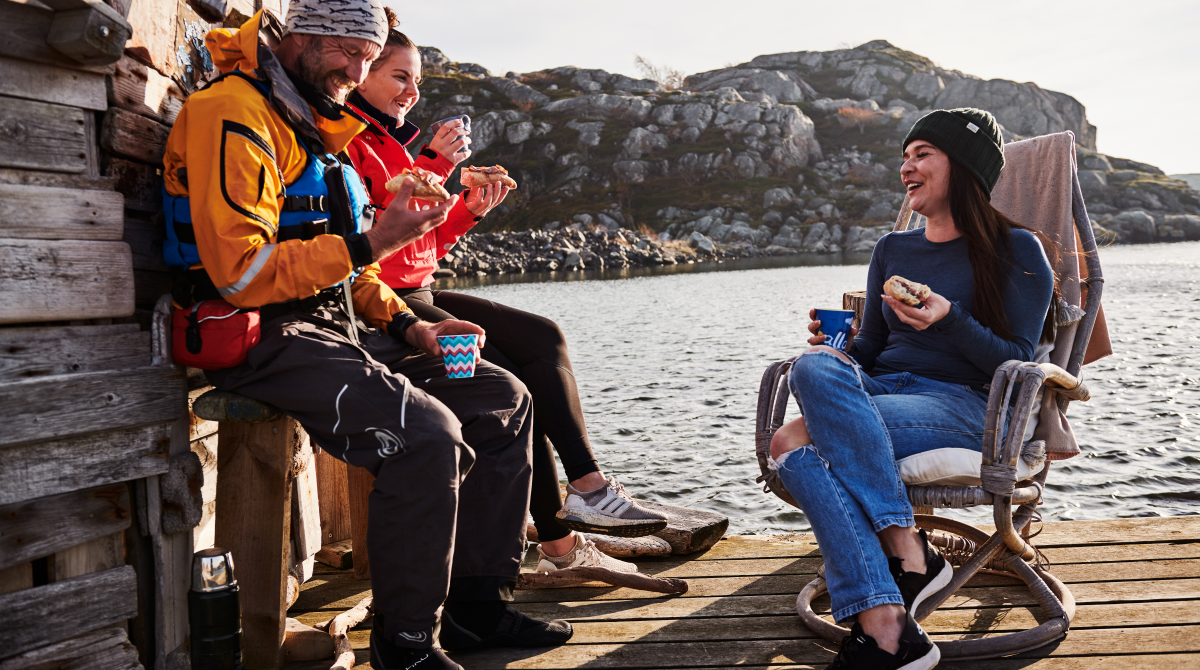Friends having a swedish fika on a jetty