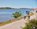 Two people are cycling on an island.