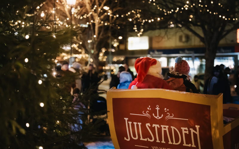 Julbelyst vintertorg med tomte i en släde