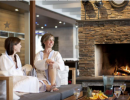 Women by the fire in white bathrobes