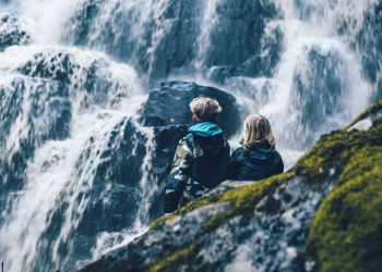 Två personer som tittar på vattenfallet Brudslöjan