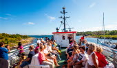 People sit on the upper deck on their way out to Koster Islands with the Koster boat.