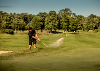 Man spelar golf på onsjö golfklubb en sommardag