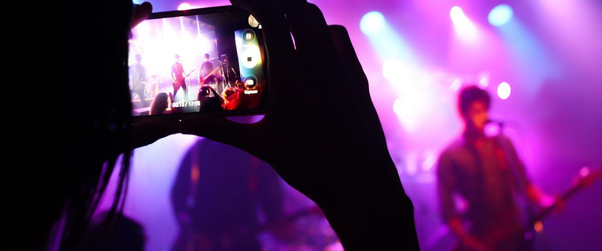 Person med mobilkamera filmar en konsert.