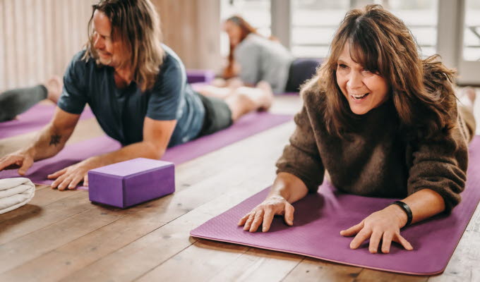 People doing yoga in a yoga studio.
