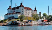 A guest harbor in front of a white castle.
