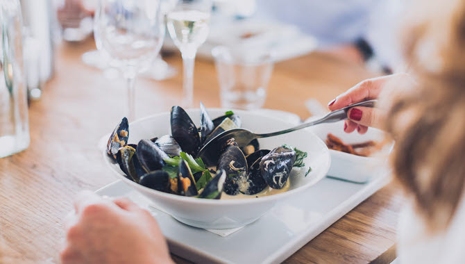 White plate with clam chowder.