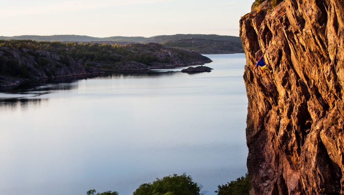 A man climbing on a massive cliff